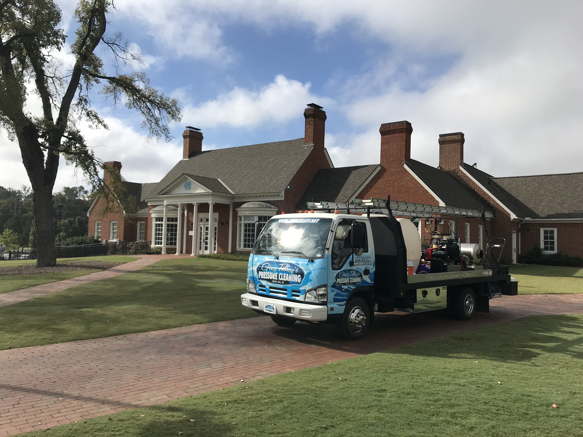 Pressure washing the exterior of the UNC office building to remove dirt and grime.