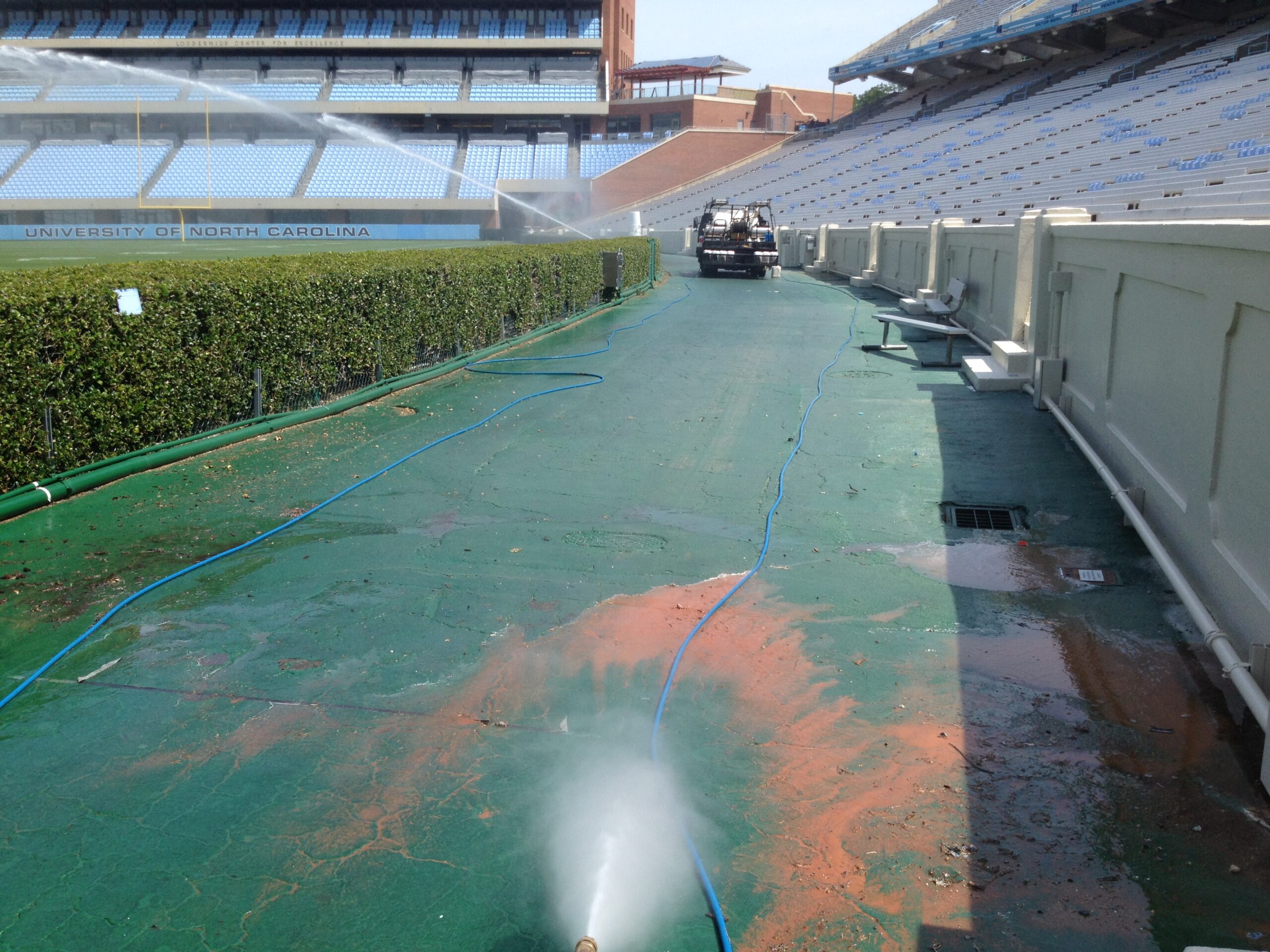 Pressure washing the ground around UNC Stadium to remove dirt and stains.