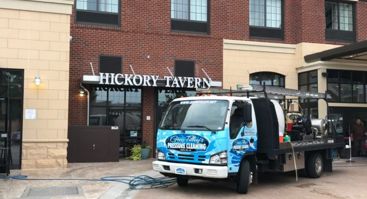 Pressure washing the exterior of Hickory Tavern to remove dirt, grime, and stains.