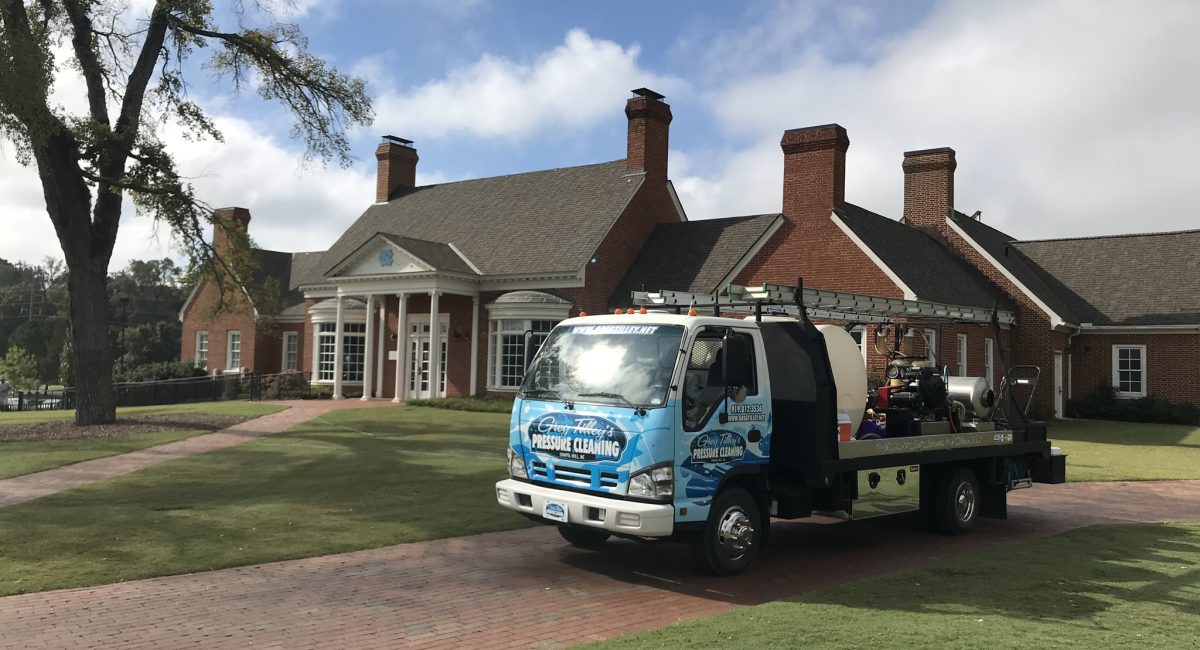 Pressure washing the exterior of the UNC office building to remove dirt and grime.